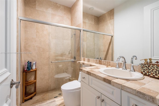 bathroom with walk in shower, toilet, and vanity