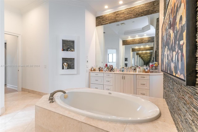 bathroom with a raised ceiling, tiled bath, crown molding, tile patterned flooring, and vanity