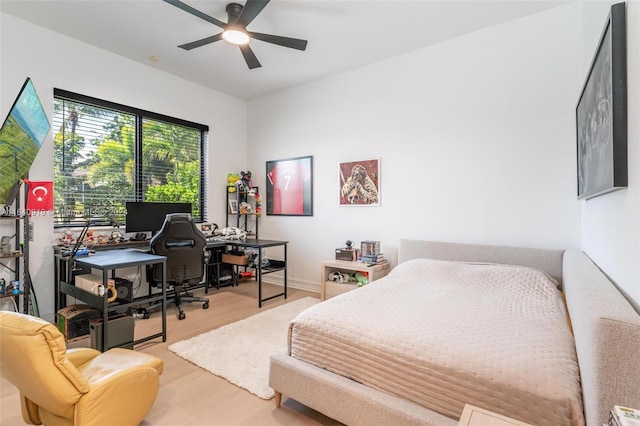 bedroom with light hardwood / wood-style flooring and ceiling fan