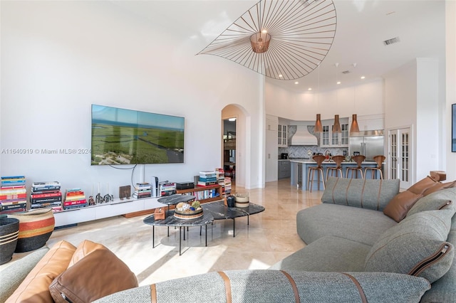 tiled living room with a high ceiling