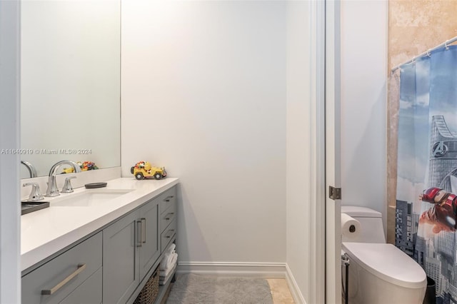 bathroom with vanity, toilet, and tile patterned flooring