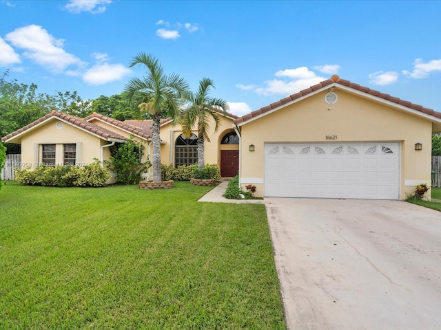 mediterranean / spanish home with a front yard and a garage