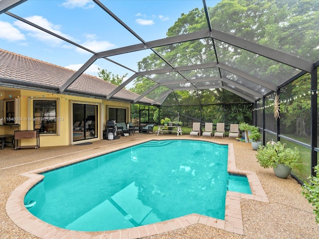 view of swimming pool featuring a lanai, an outdoor hangout area, and a patio area