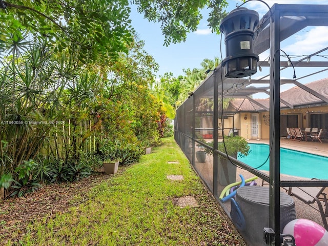 view of yard with a lanai and a patio