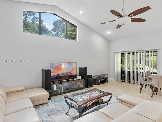 living room featuring high vaulted ceiling, ceiling fan, light tile patterned floors, and a textured ceiling