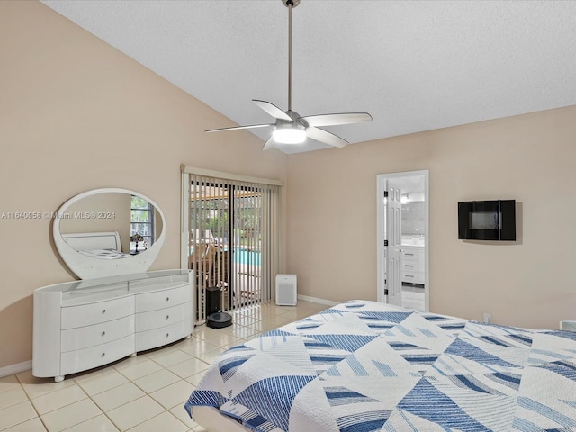 bedroom featuring a textured ceiling, vaulted ceiling, light tile patterned floors, ensuite bathroom, and ceiling fan