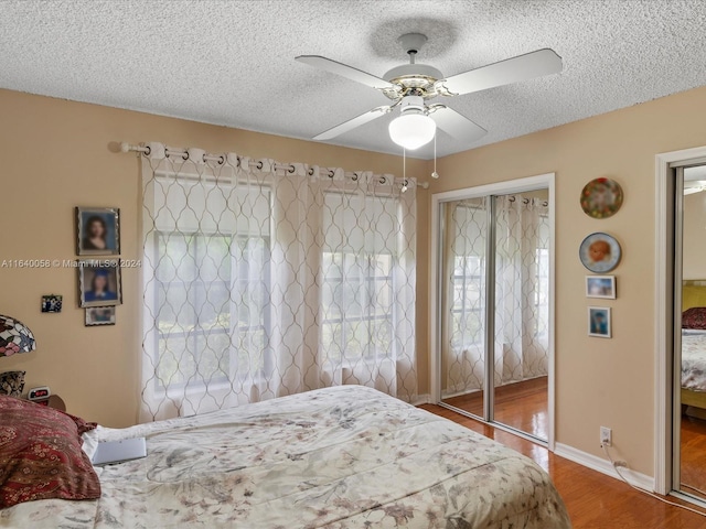 bedroom featuring a closet, wood-type flooring, a textured ceiling, and ceiling fan