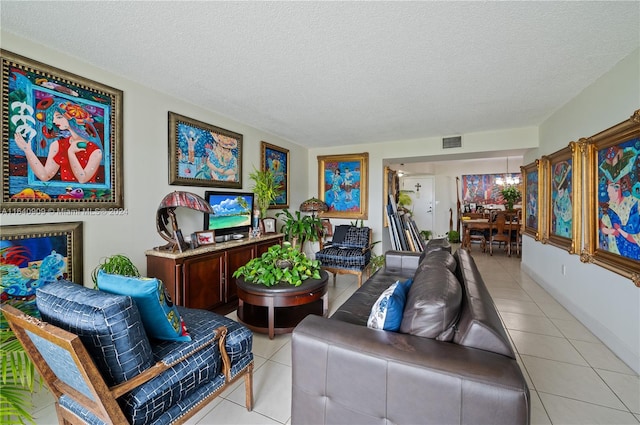 living room featuring a textured ceiling and light tile patterned floors