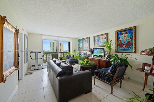 living room featuring floor to ceiling windows, light tile patterned flooring, and a textured ceiling