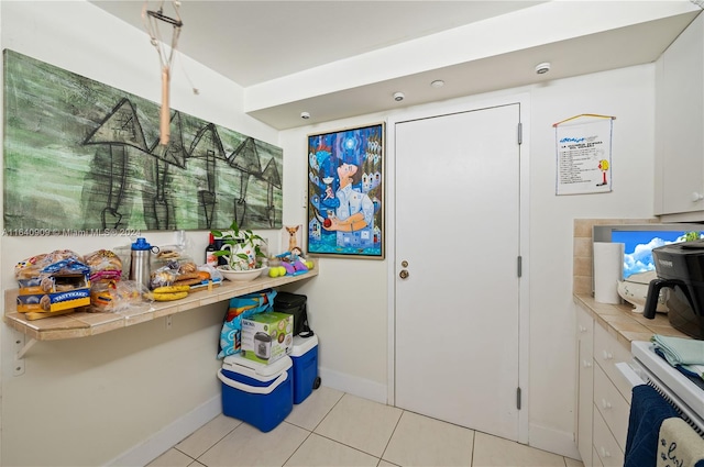 kitchen featuring white electric range and light tile patterned floors