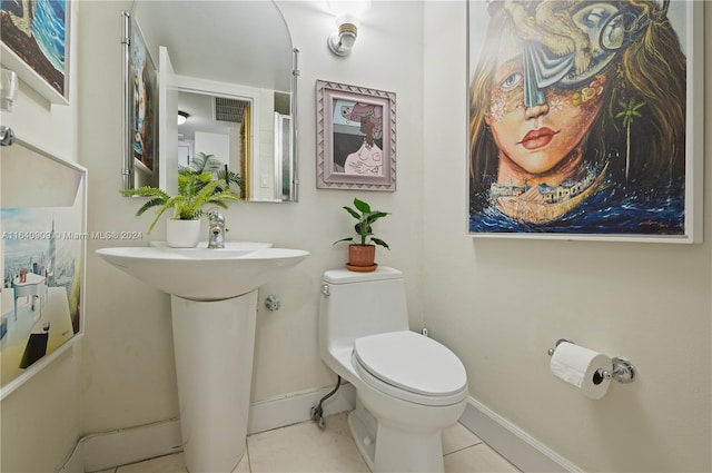 bathroom featuring toilet and tile patterned floors