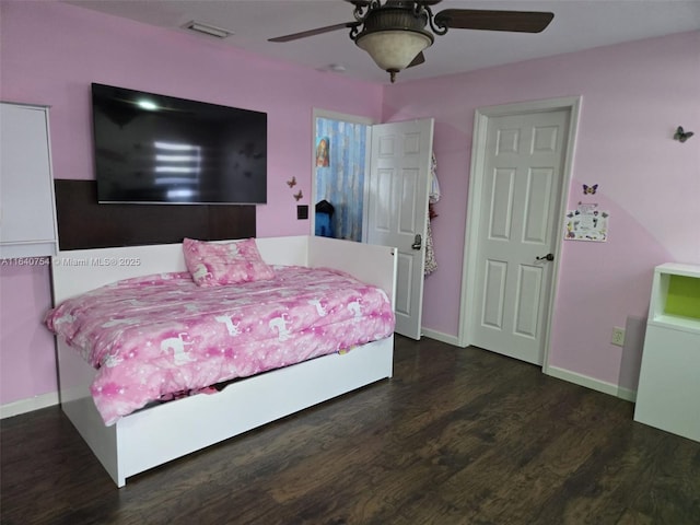 bedroom featuring ceiling fan and dark hardwood / wood-style floors