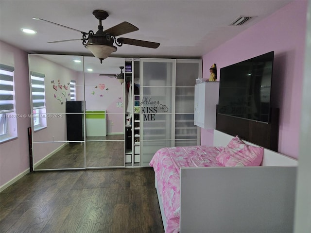 bedroom with dark hardwood / wood-style floors and ceiling fan