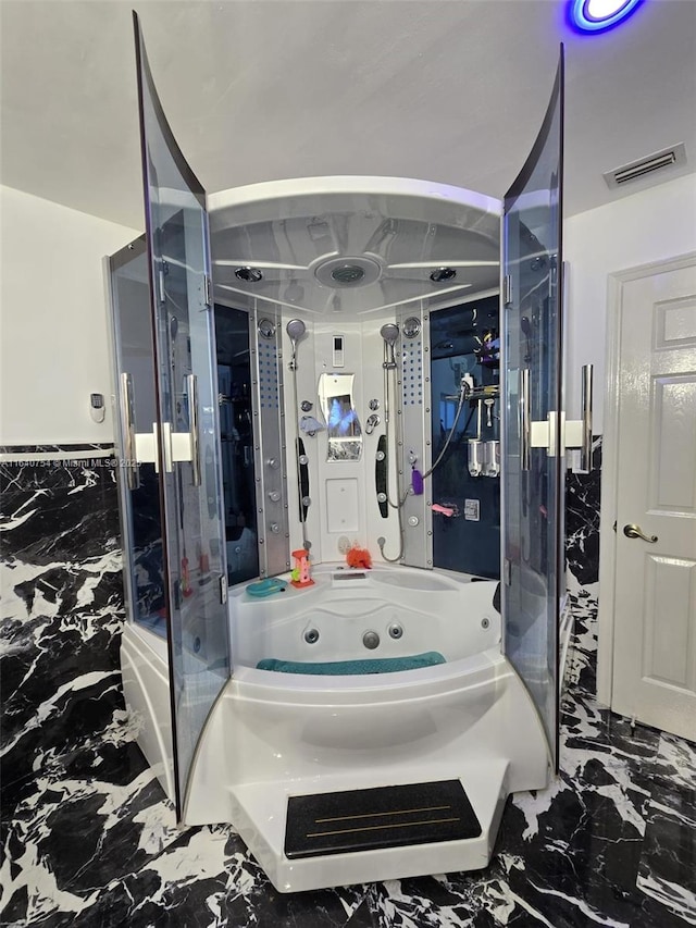 bathroom featuring tile walls and separate shower and tub