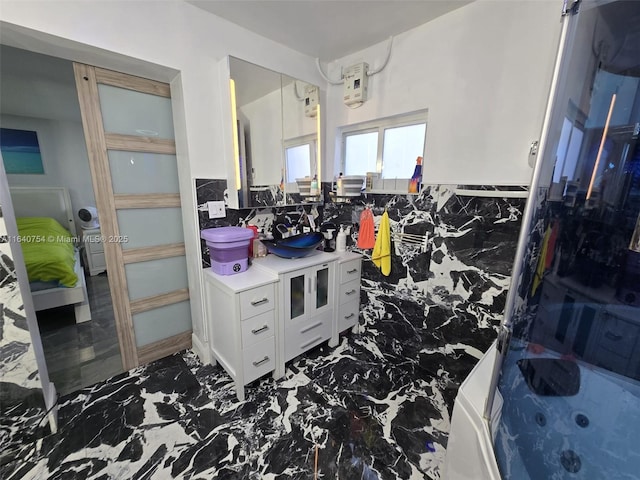 bathroom featuring vanity, bathtub / shower combination, and tile walls