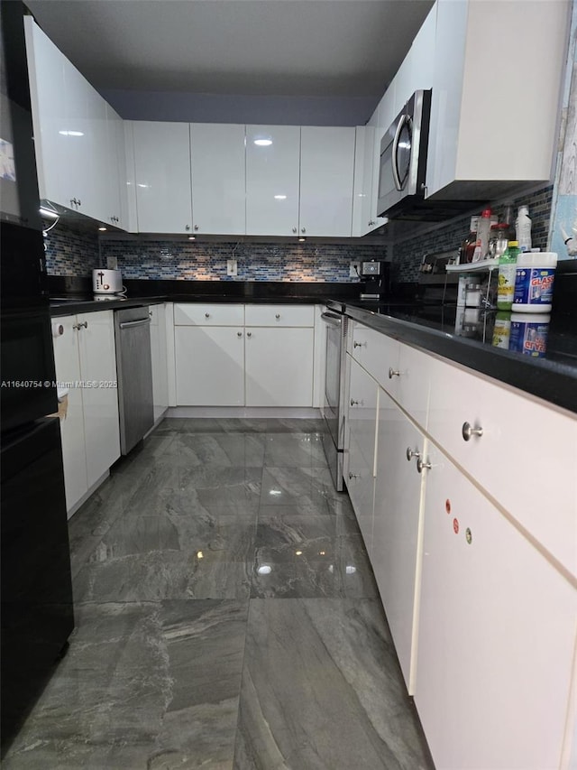 kitchen with white cabinetry, appliances with stainless steel finishes, and decorative backsplash