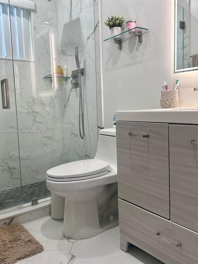 bathroom with tile patterned flooring, toilet, vanity, and an enclosed shower