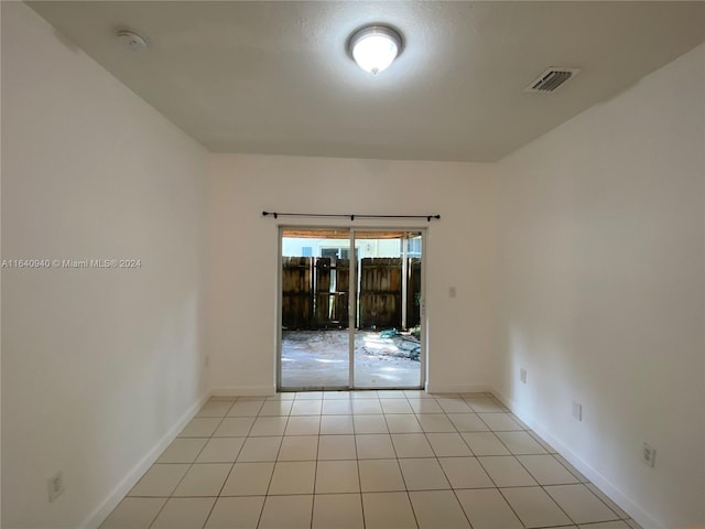 empty room with light tile patterned floors