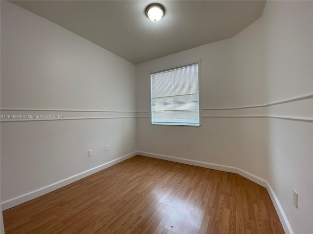 unfurnished room with light hardwood / wood-style flooring