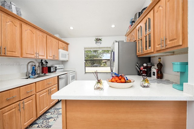 kitchen featuring a textured ceiling, stainless steel appliances, and sink