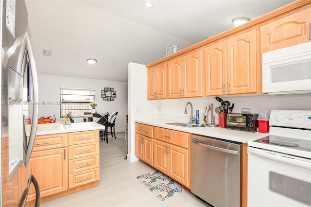 kitchen featuring light hardwood / wood-style floors, stainless steel appliances, sink, and light brown cabinets