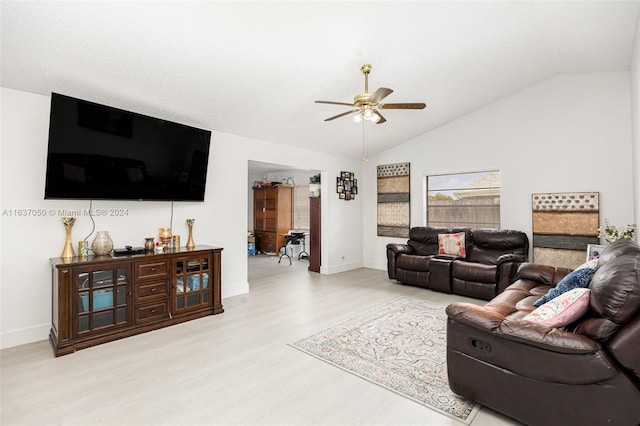 living room featuring light hardwood / wood-style flooring, ceiling fan, and vaulted ceiling