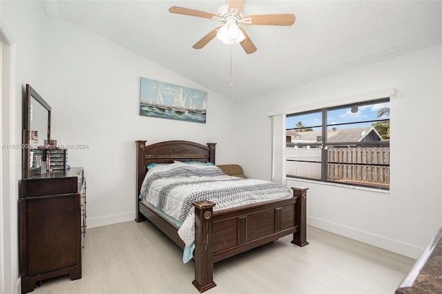 bedroom featuring ceiling fan, lofted ceiling, and light hardwood / wood-style floors