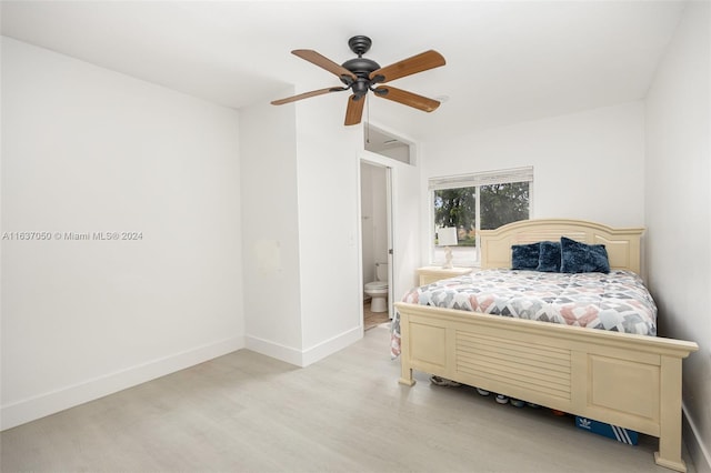 bedroom with connected bathroom, ceiling fan, and light wood-type flooring