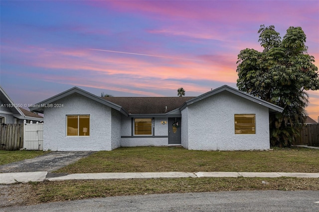 single story home with a yard