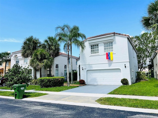 mediterranean / spanish home with a garage and a front lawn