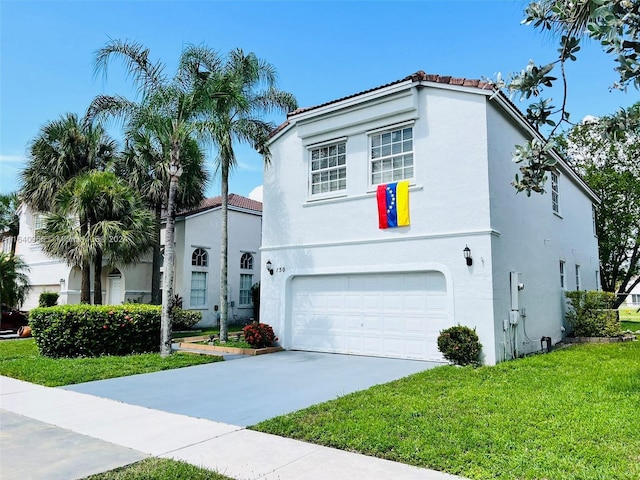 mediterranean / spanish house with a front yard and a garage