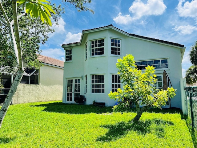 rear view of house with a lawn