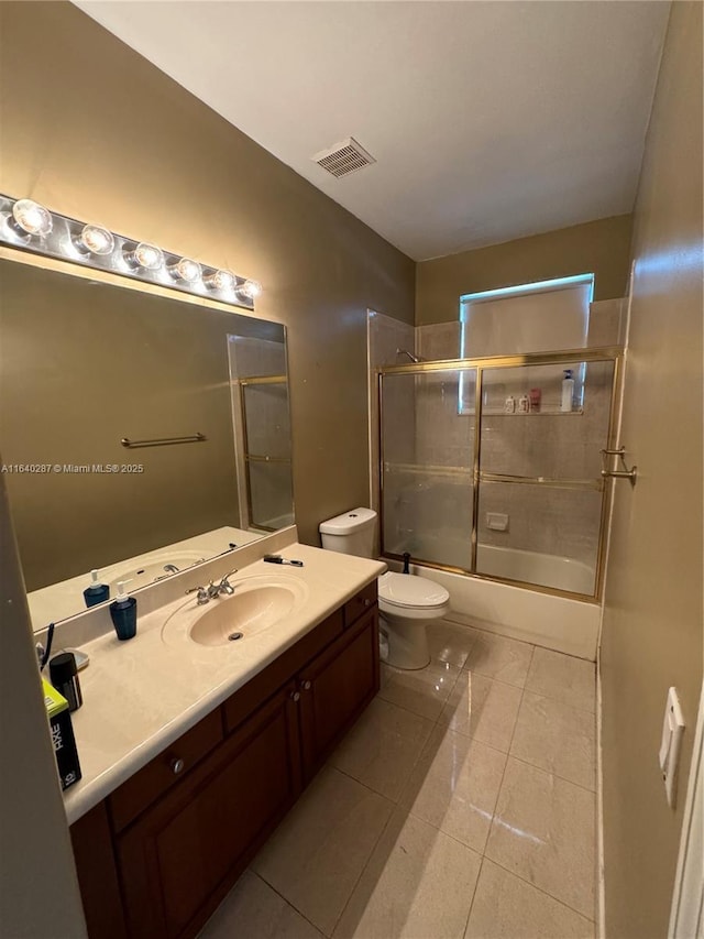 full bathroom with vanity, toilet, tile patterned flooring, and combined bath / shower with glass door