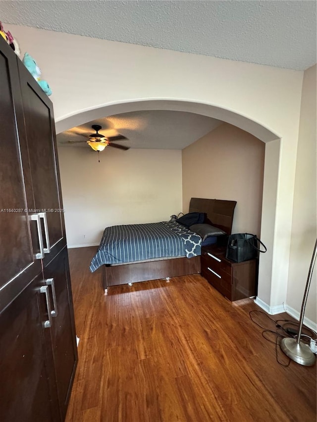 bedroom with hardwood / wood-style floors and a textured ceiling