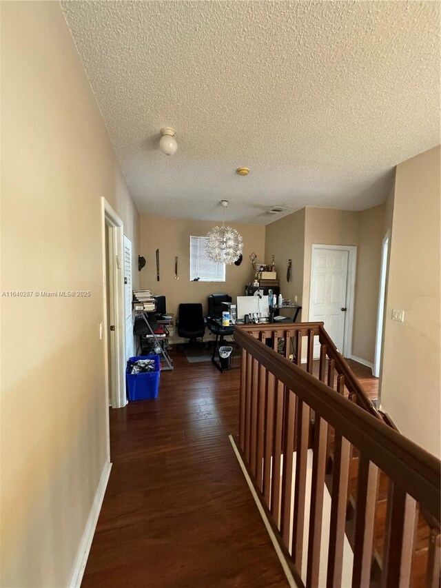 bedroom with ceiling fan, dark wood-type flooring, and a textured ceiling