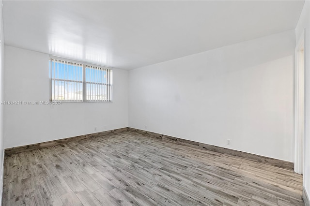 empty room with light hardwood / wood-style floors