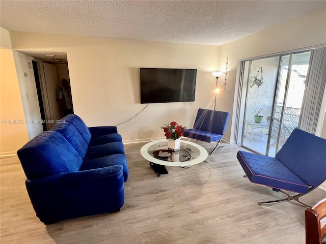 living room featuring a textured ceiling and hardwood / wood-style floors