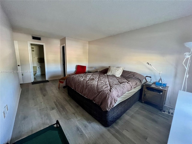 bedroom with hardwood / wood-style flooring