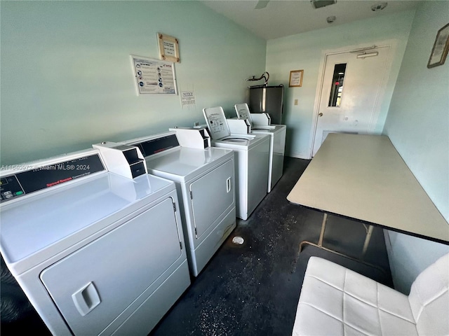 laundry area with water heater and washer and clothes dryer