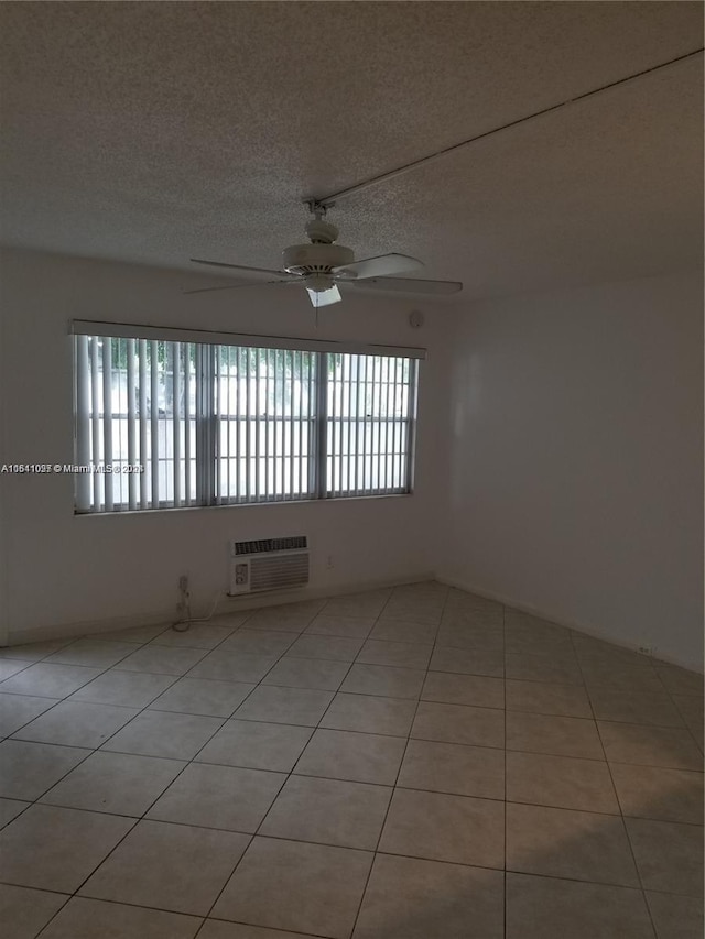 186 Ventnor L Unit 186, Deerfield Beach, FL 33442 - unfurnished room with an AC wall unit, ceiling fan, light tile patterned floors, and a textured ceiling