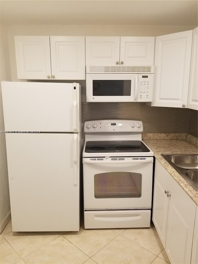 186 Ventnor L Unit 186, Deerfield Beach, FL 33442 - kitchen with white appliances, white cabinets, light tile patterned floors, and light countertops