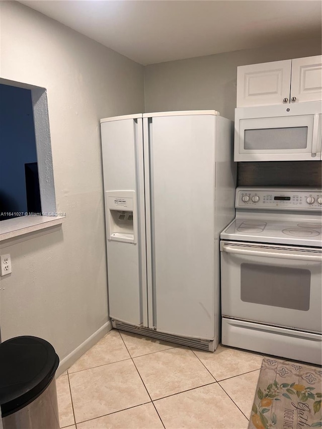 kitchen featuring white cabinets, white appliances, and light tile patterned floors