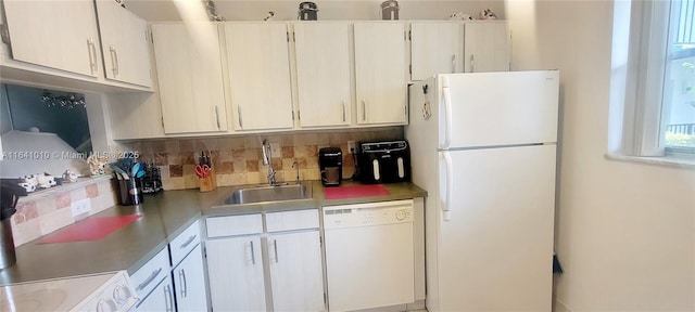 kitchen featuring sink, white cabinets, tasteful backsplash, and white appliances