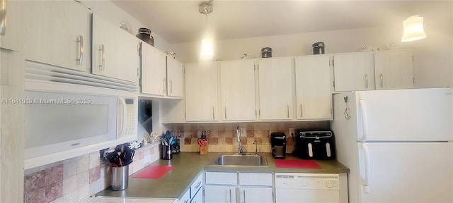 kitchen with decorative light fixtures, sink, white appliances, and white cabinetry