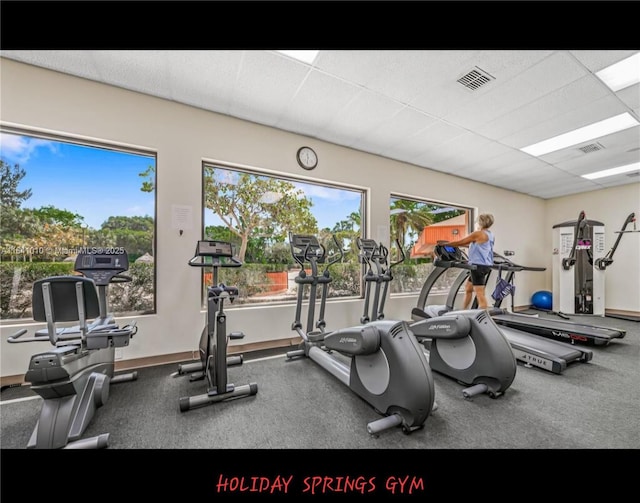 exercise room featuring a paneled ceiling