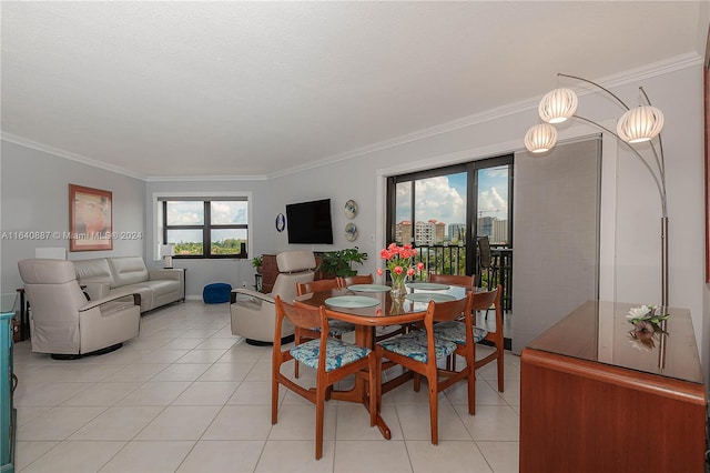 dining space with light tile patterned floors and crown molding