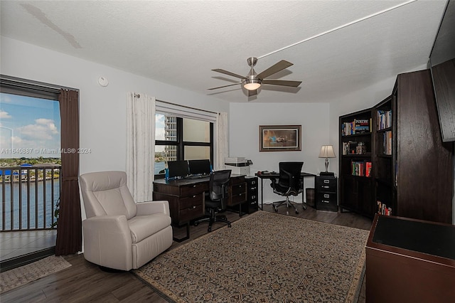 office with ceiling fan, dark hardwood / wood-style floors, and a textured ceiling