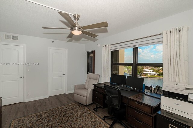 office featuring ceiling fan, hardwood / wood-style flooring, and a textured ceiling