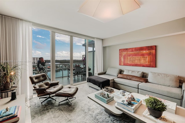 living room featuring expansive windows and a water view