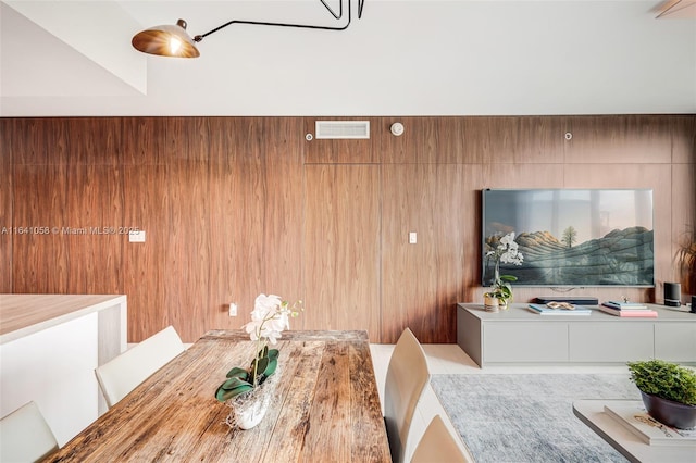 dining room featuring wooden walls